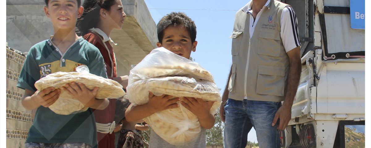 distributing bread loaf in northern rural homs